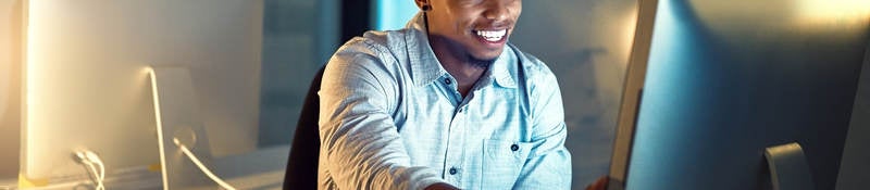 Shot of a young businessman working late in an office