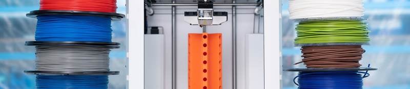 Spools of 3D printing filament and a 3D printer
