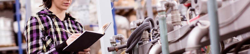 female engineer inspects industrial equipment
