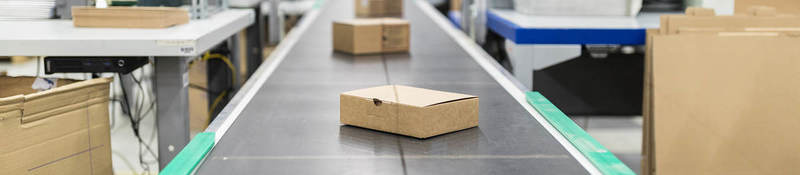 Photo of cardboard boxes on a conveyor belt