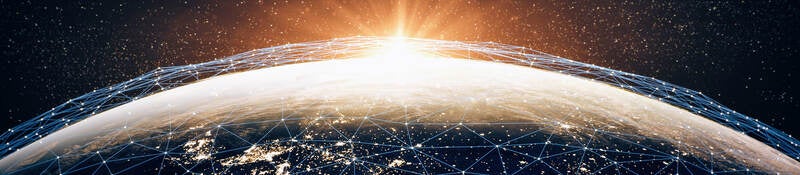 A series of interconnecting points of light across the earth, representing cybersecurity. 