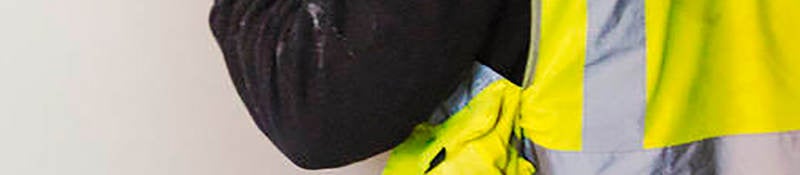 Construction worker carrying drywall