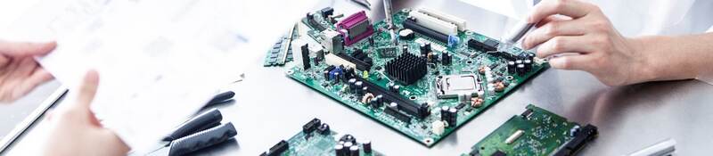 Lab tech working on electronic device