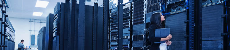 Woman with an iPad inspecting a server center