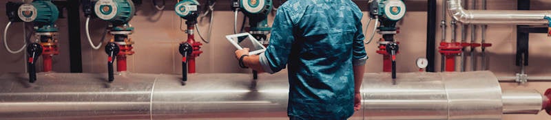 Electrical engineer working in an industrial boiler control room