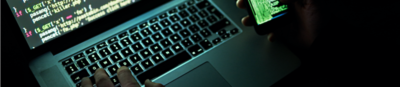 malware code on a laptop monitor