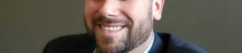 Man wearing suit smiling at camera
