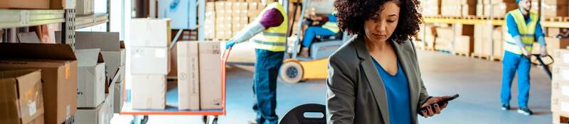 Person working on a laptop in a warehouse