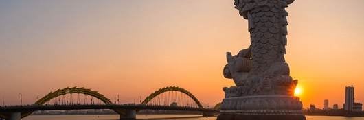 view of the dragon bridge over the water in da nong, vietnam