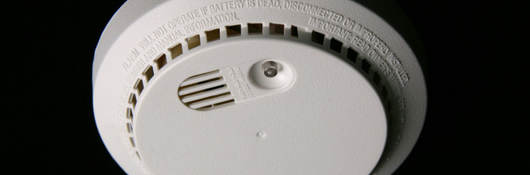 Man testing smoke alarm