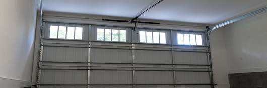 a closed, garage door with automatic opener centered to image.