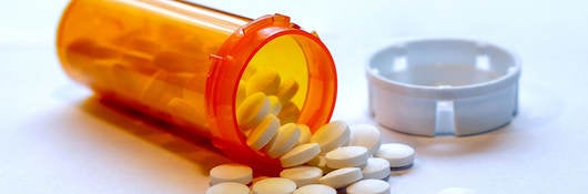 opioid crisis - open bottle of prescription painkiller pills