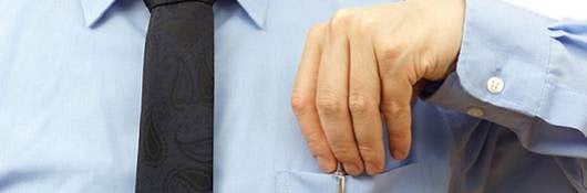 businessman is putting pen back into his pocket