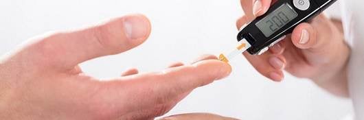 doctors hand holding glucose measure scanning pen on patients finger