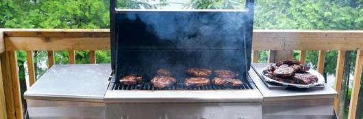 Steaks cooking on a gas grill