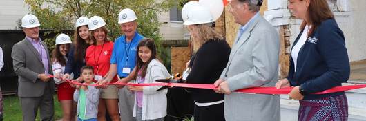UL sponsors stand with Habitat for Humanity officials at a ribbon cutting ceremony