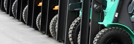Multiple forklifts in a row in warehouse