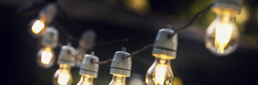 A strand of string lights in an outdoor setting. 
