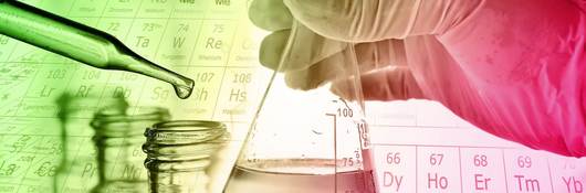 Flask in scientist hand with test tube in rack