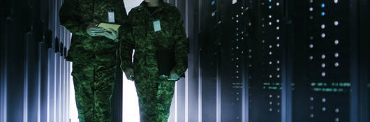 Two military men walking in data center corridor