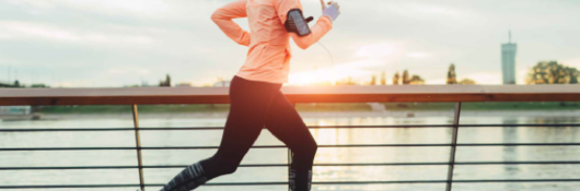 Woman running by water