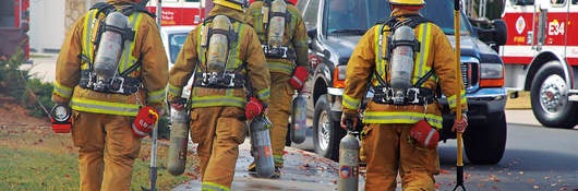 firefighters next to their truck