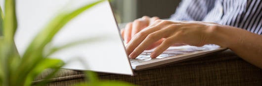Close up of laptop on person's lap