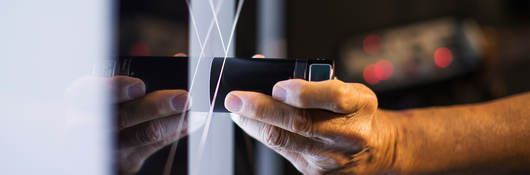 scientist takes measurement on glass