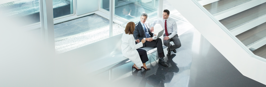 3 persons sitting on bench new glass window talking
