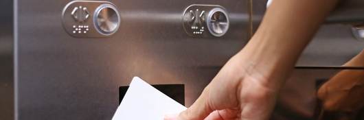 A worker scans an identification card to access an access control system
