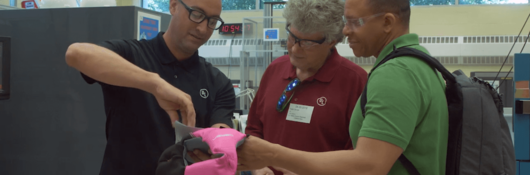 UL staff examines the updated label on a pink life jacket at our Research Triangle Park facility