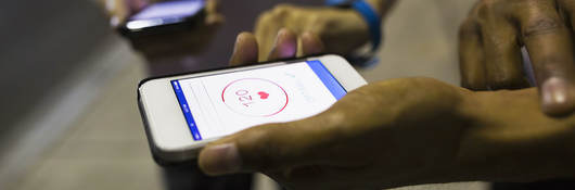 Two people using an app to check their health