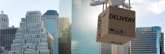 Drone attempts to deliver package in city landscape.