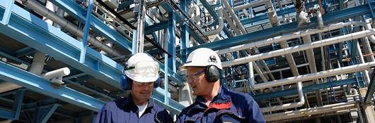two workers at oil refinery