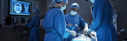 Surgeons with  a patient in an operating room
