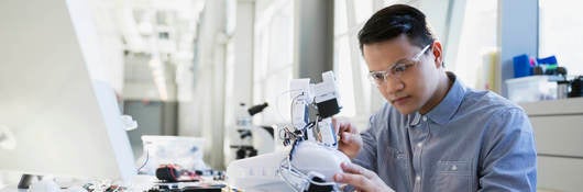 Worker working on a small robot