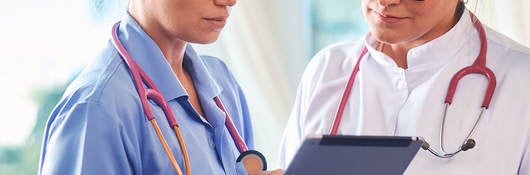 Doctors looking into the tablet mobile device