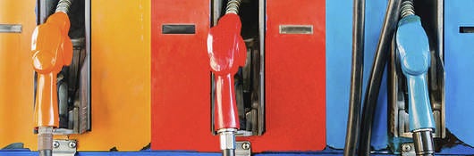 A line of fueling pumps at a fuel dispensing station