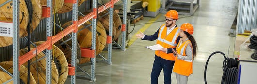 Workers auditing a warehouse
