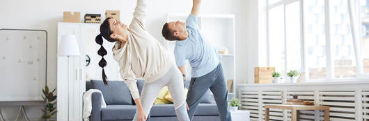 Photo of a couple doing yoga in activewear