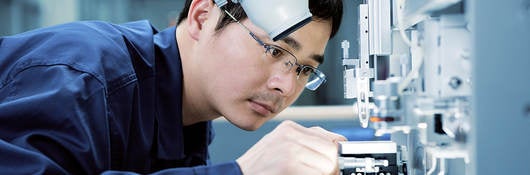 man-looking-through-microscope-in-laboratory