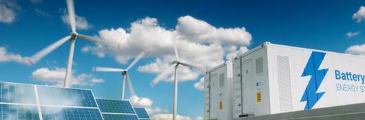 Photovoltaics, wind turbines and Li-ion battery container in fresh nature.