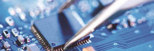 Tweezers over a circuit board