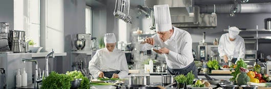 foodservice professionals (chefs) in a high-end commercial kitchen 