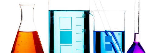 Lab beakers containing different colored liquids