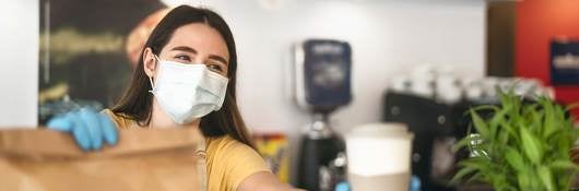 Foodservice worker following safety guidelines and wearing proper safety equipment