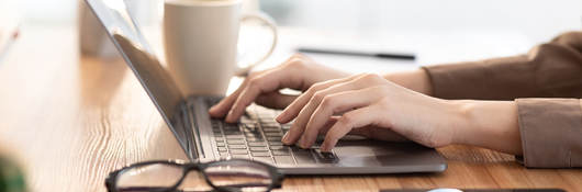 woman typing on a laptop keyboard