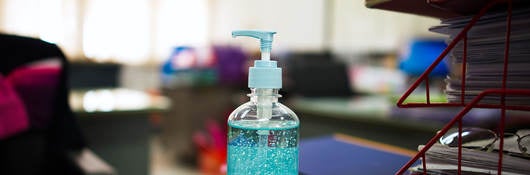 Bottle of hand sanitizing gel on an office desk