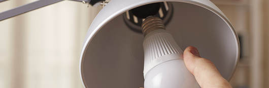 Person changing light bulb