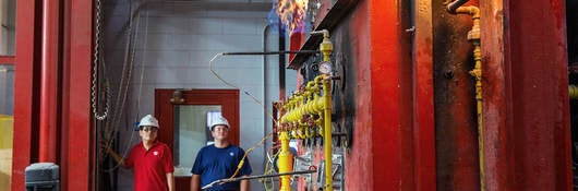 Two engineers performing a column fire test